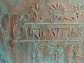 Curiosities sign in bronze and verdigris Royalty Free Stock Photo